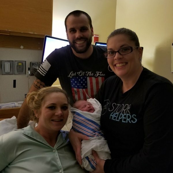 Tamara holding baby with couple